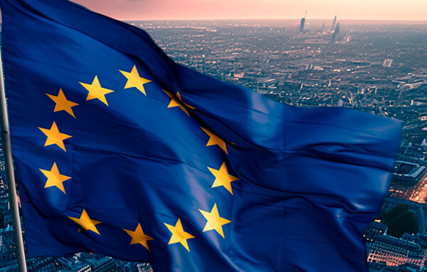 The developing flag of the European Union in the background of a European city and buildings